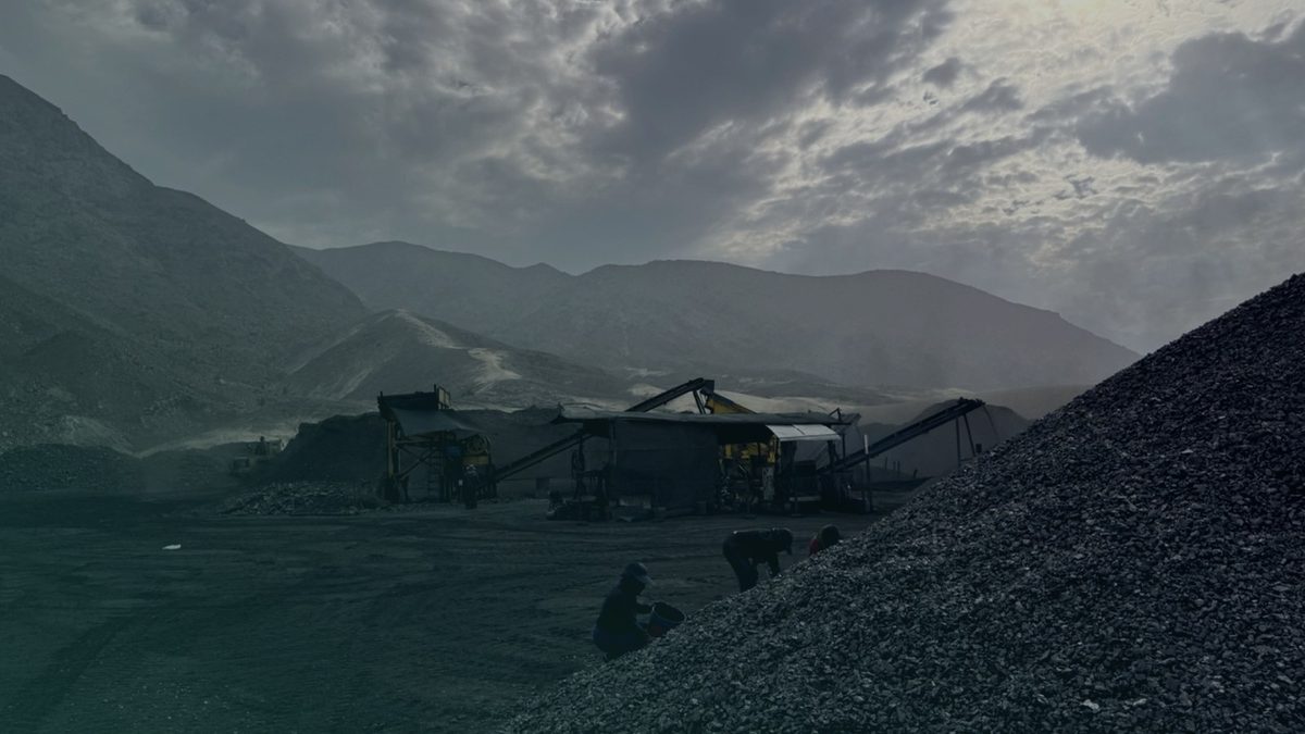 Anthracite stockpiles and machinery at a mining site